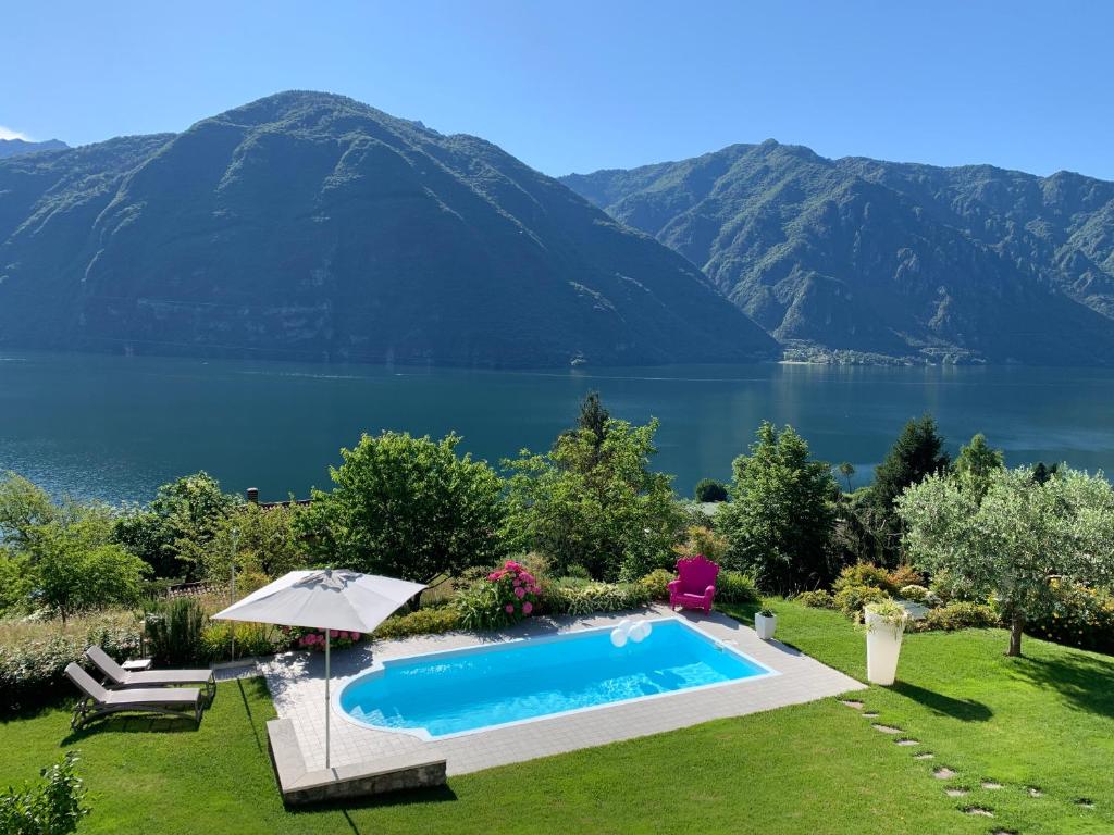 a swimming pool with a view of a lake and mountains at B&B Re' Perone in Anfo
