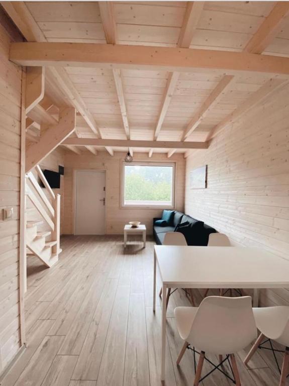a room with a table and chairs and a couch at Nad Rozlewiskiem in Bobolin
