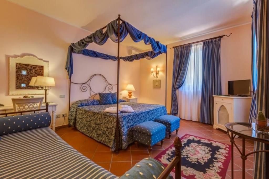 Postel nebo postele na pokoji v ubytování Il Borgo Country Resort