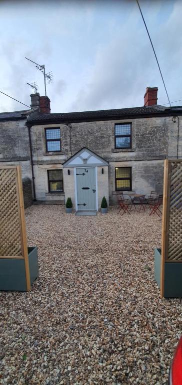 a building with a white garage in front of it at Quirky Cottage - Dogs Welcome - Free 24 hr Cancellation's in Corsham