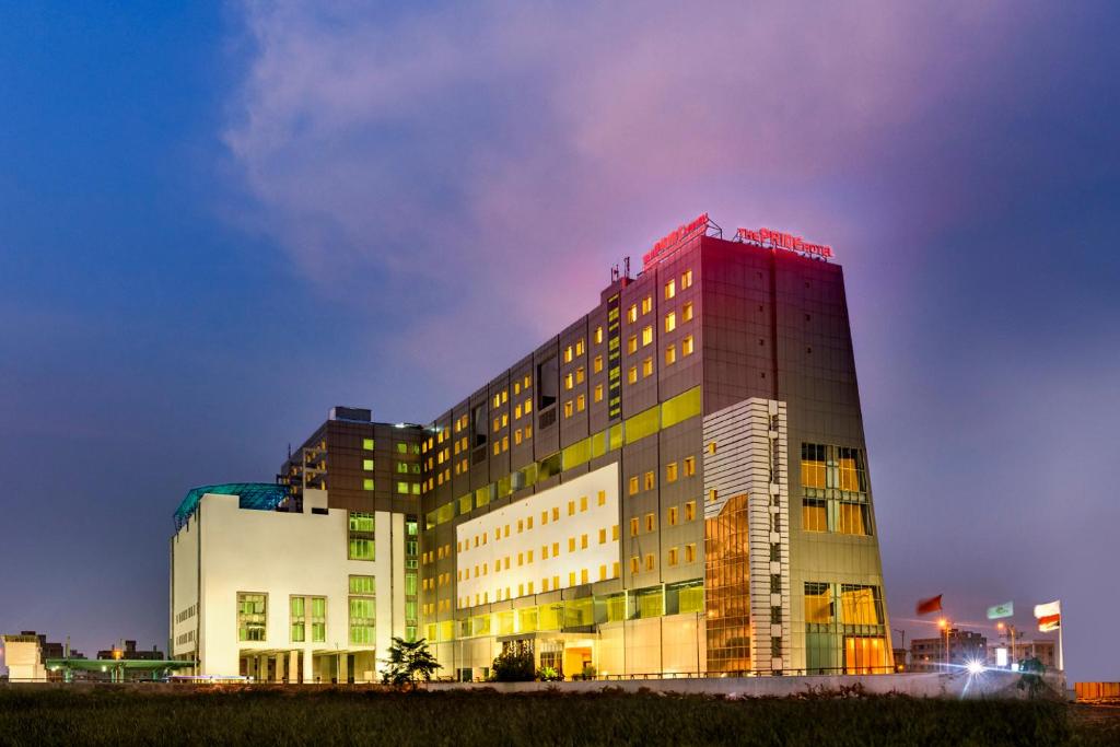 a tall building with a red at Pride Plaza Hotel, Kolkata in Kolkata