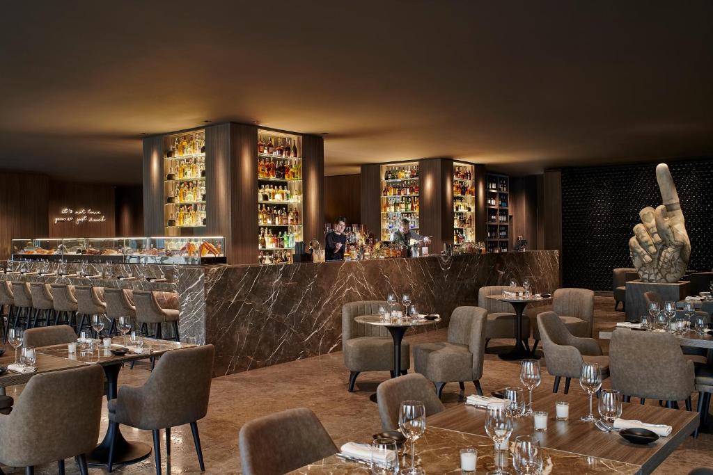 a restaurant with tables and chairs and a bar at Four Seasons Hotel Cairo at Nile Plaza in Cairo