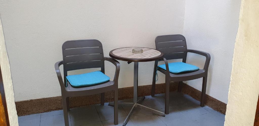 two chairs and a table and a table and two chairs at Apartment Rafael in Senj