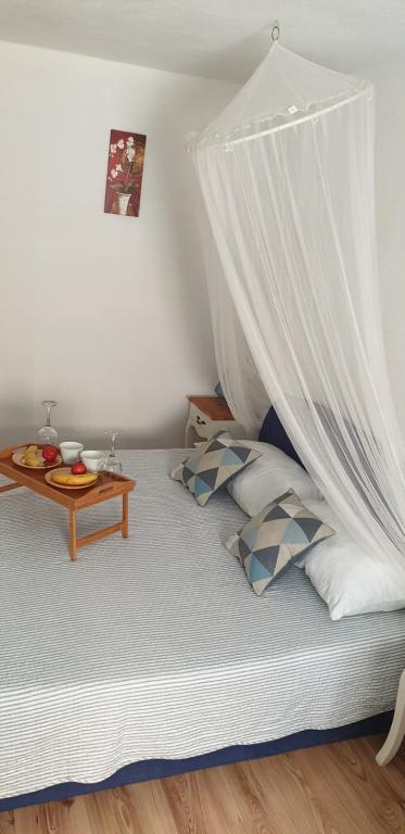 a bedroom with a bed with a mosquito net at Apartment Rafael in Senj
