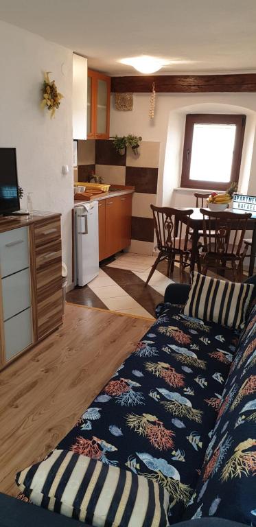 a living room with a couch and a kitchen at Apartment Rafael in Senj