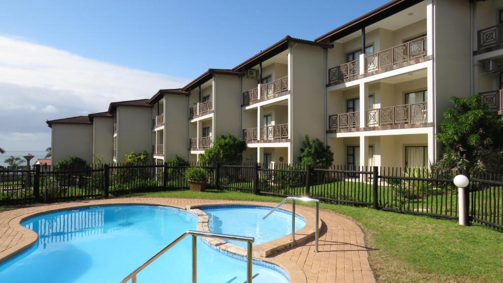 an image of an apartment building with a swimming pool at 7 Topanga in Uvongo Beach