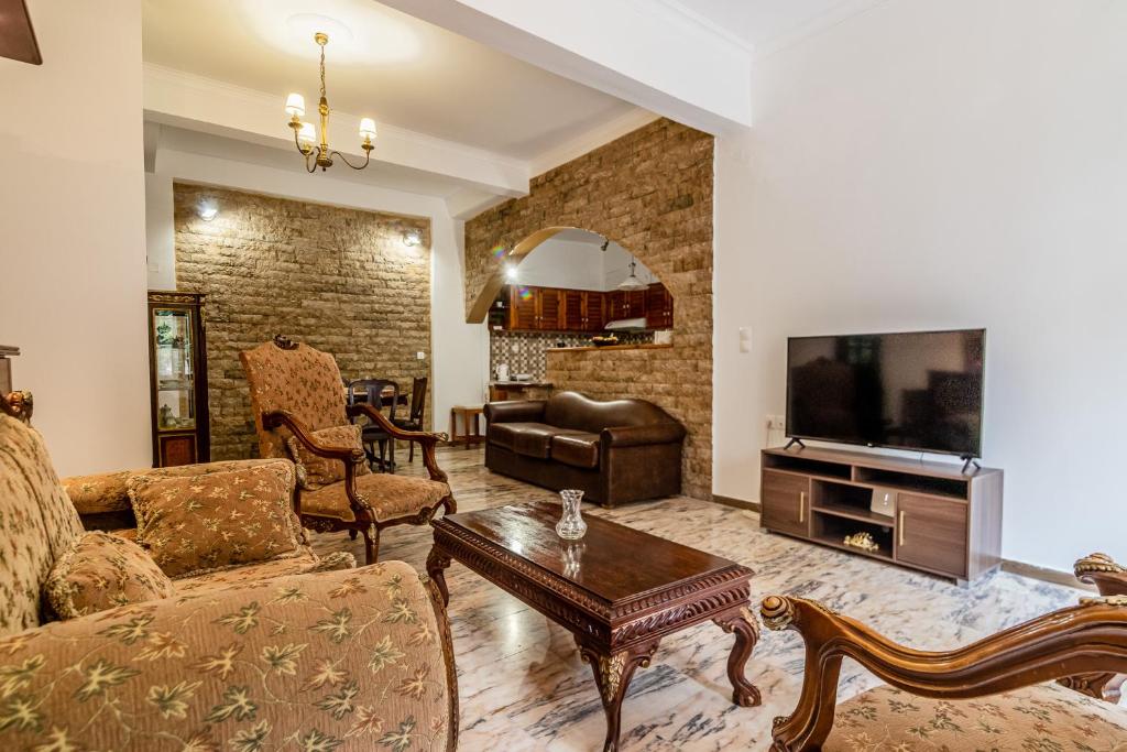 a living room with a couch and a tv at Casa Del Fantino in Chania