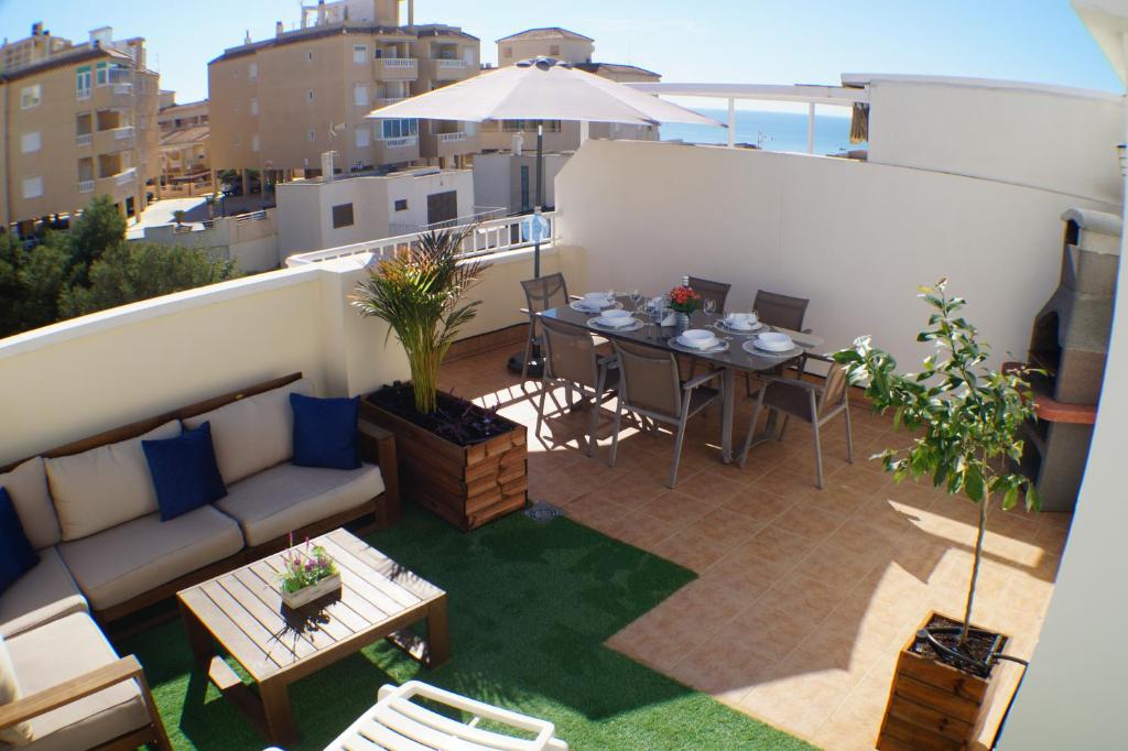 patio con sofá y mesa en el balcón en Apartment Sunny Harbour, en Santa Pola