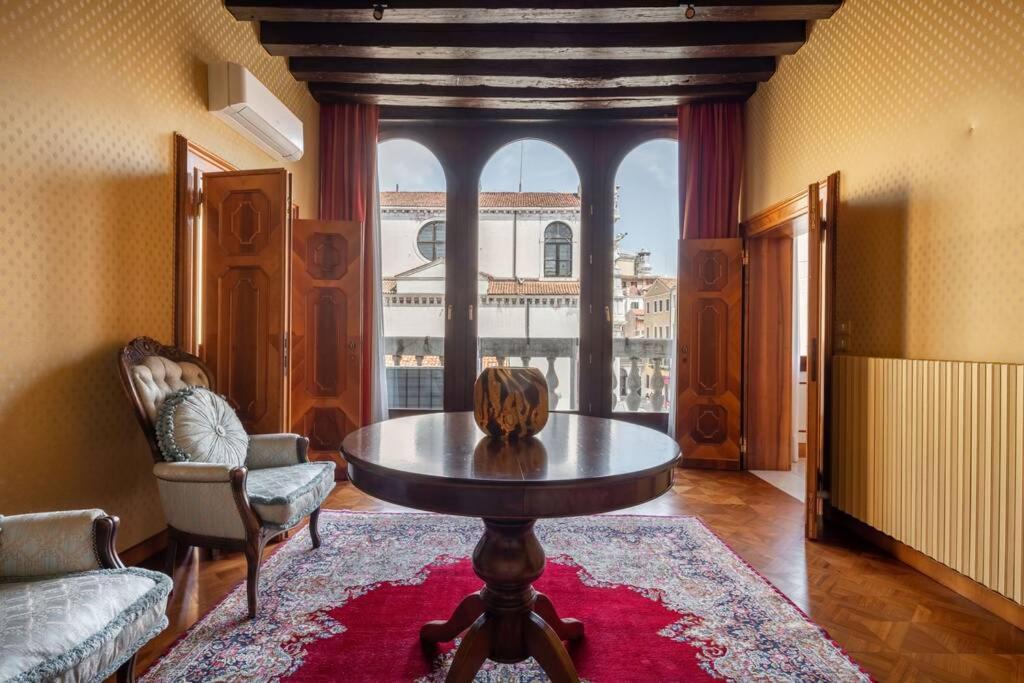 a living room with a table and a large window at Giglio Suite 2476 in Venice