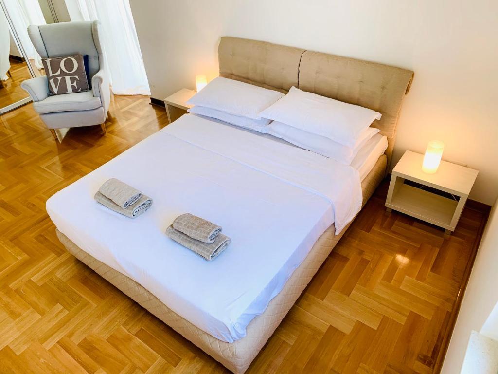 a bedroom with a bed with two towels on it at Lavender Bay Apartment C32 in Donji Morinj