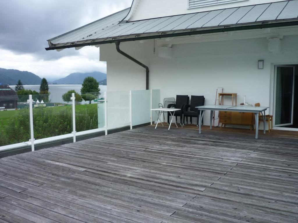 a deck with a table and chairs on a house at Fewo Ossiach in Ossiach