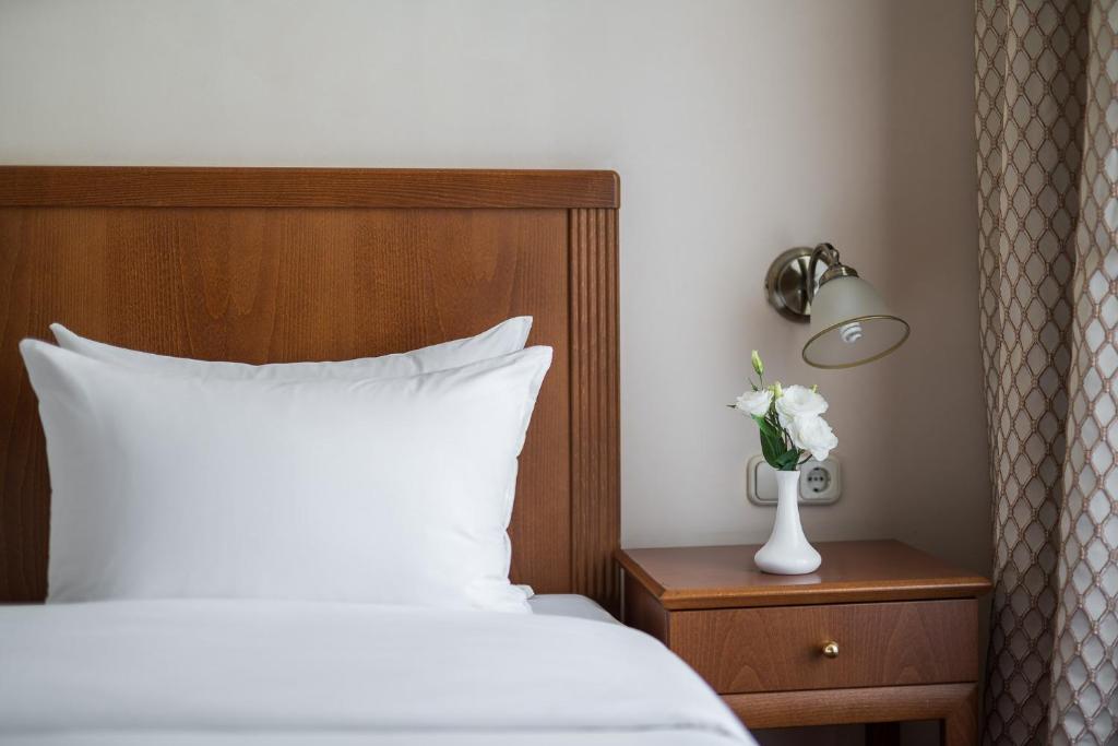 Postel nebo postele na pokoji v ubytování Mozart Hotel
