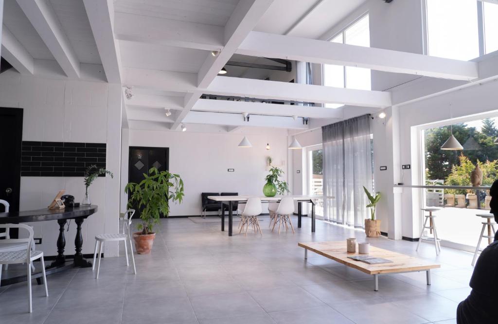 a large living room with a table and chairs at 87029house in Scalea