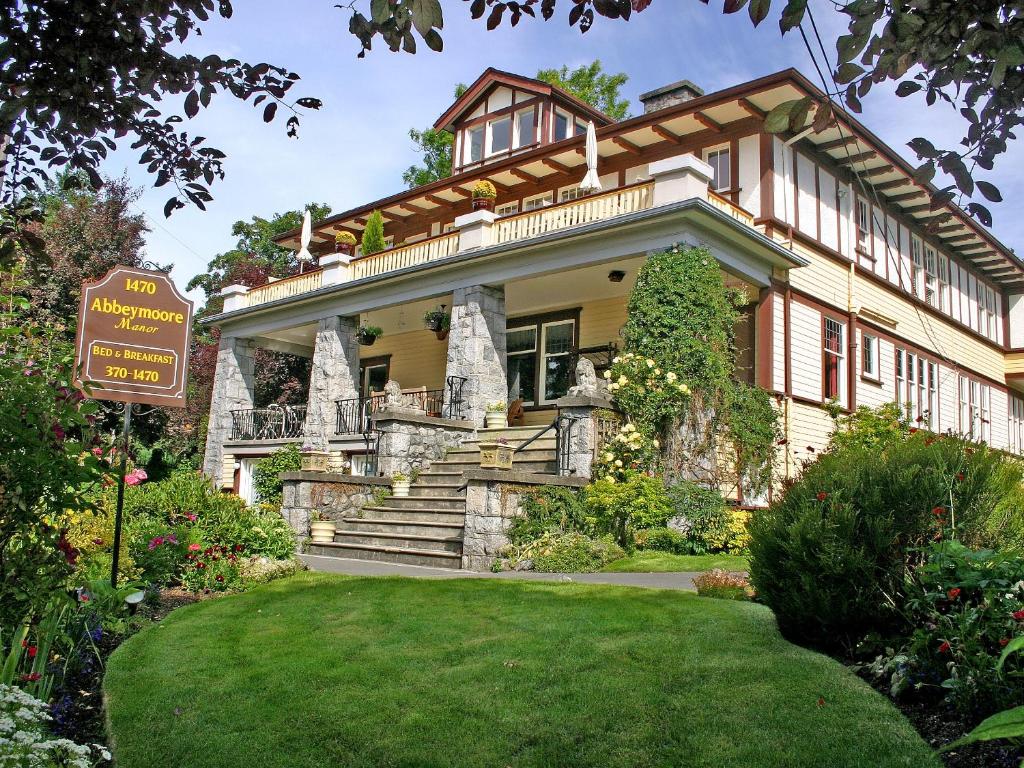 a large house with a sign in front of it at Abbeymoore Manor in Victoria