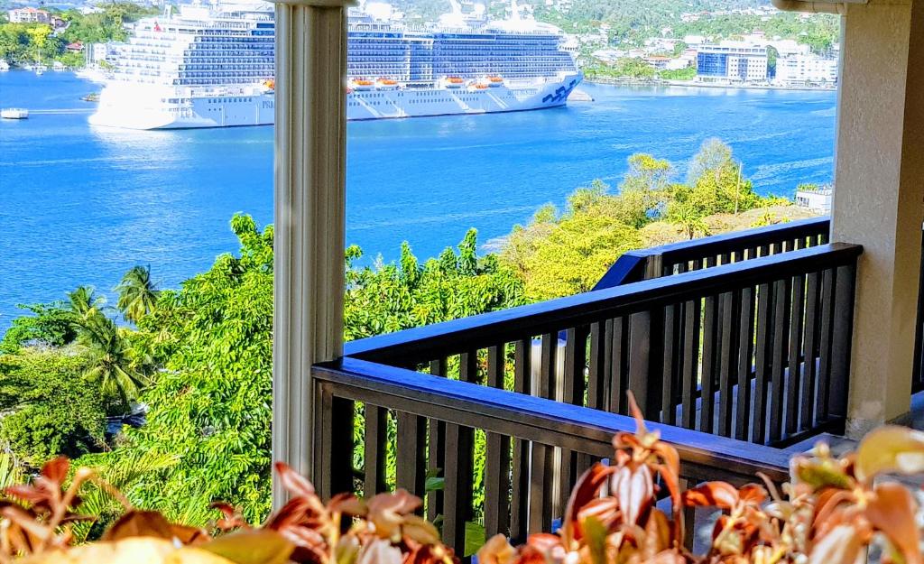 a balcony with a view of the ocean and cruise ships at Ocean Crest in Castries