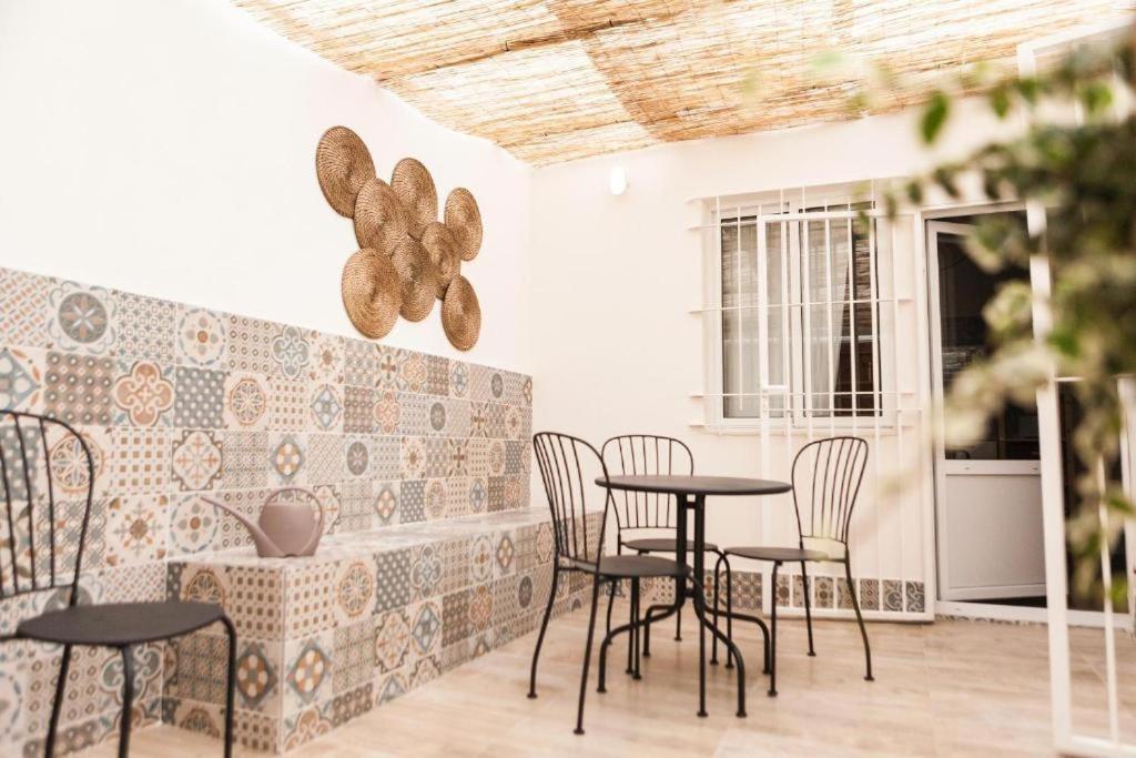 a patio with tables and chairs in a room at Marxalenes Apartments in Valencia