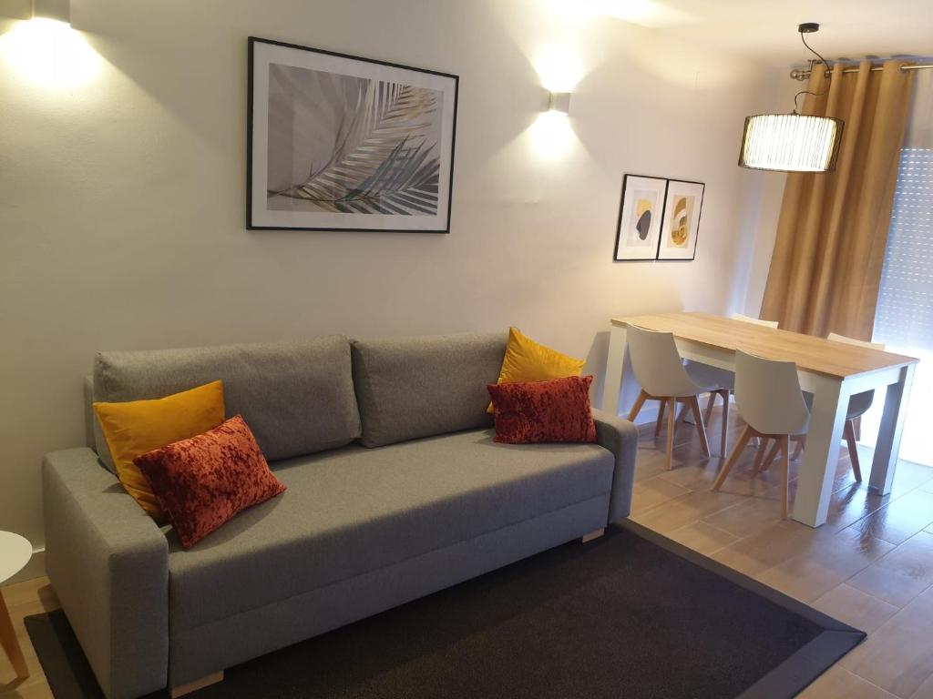 a living room with a couch and a dining room table at Maxx Apartamento in Salou