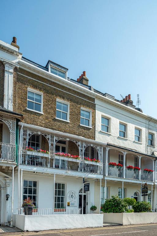 a large brick building with balconies on a street at Hamiltons Boutique Hotel in Southend-on-Sea