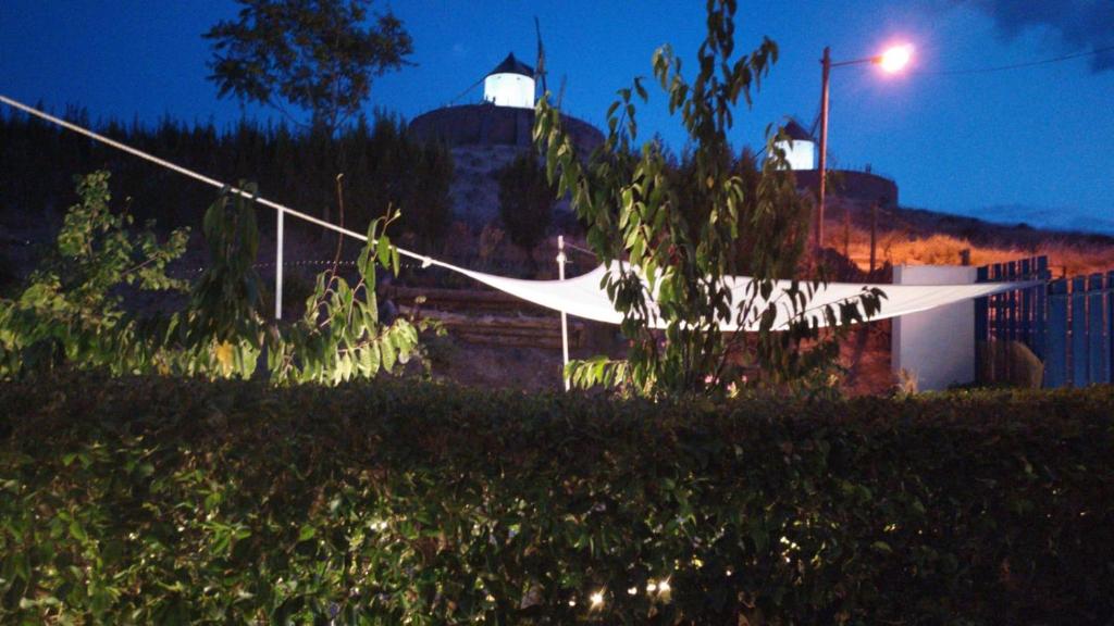 a fence with a hammock in a yard at night at El Retiro de la Mancha in Consuegra