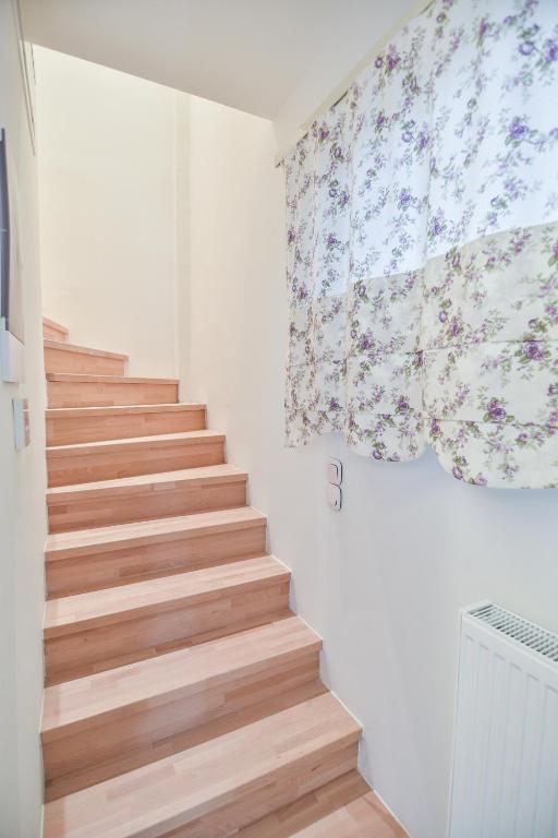 a staircase in a room with white walls and wooden floors at On Board Luxury Studios in Sarti