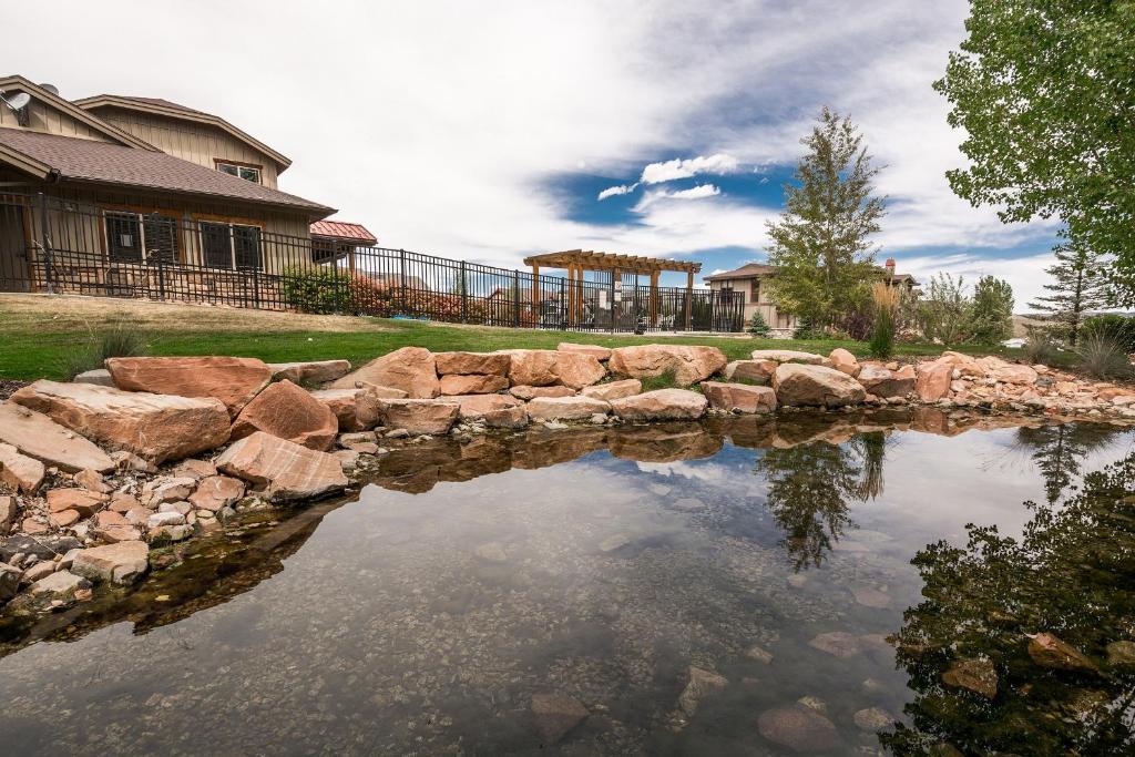 a pond in front of a house at Bear Hollow Village in Park City