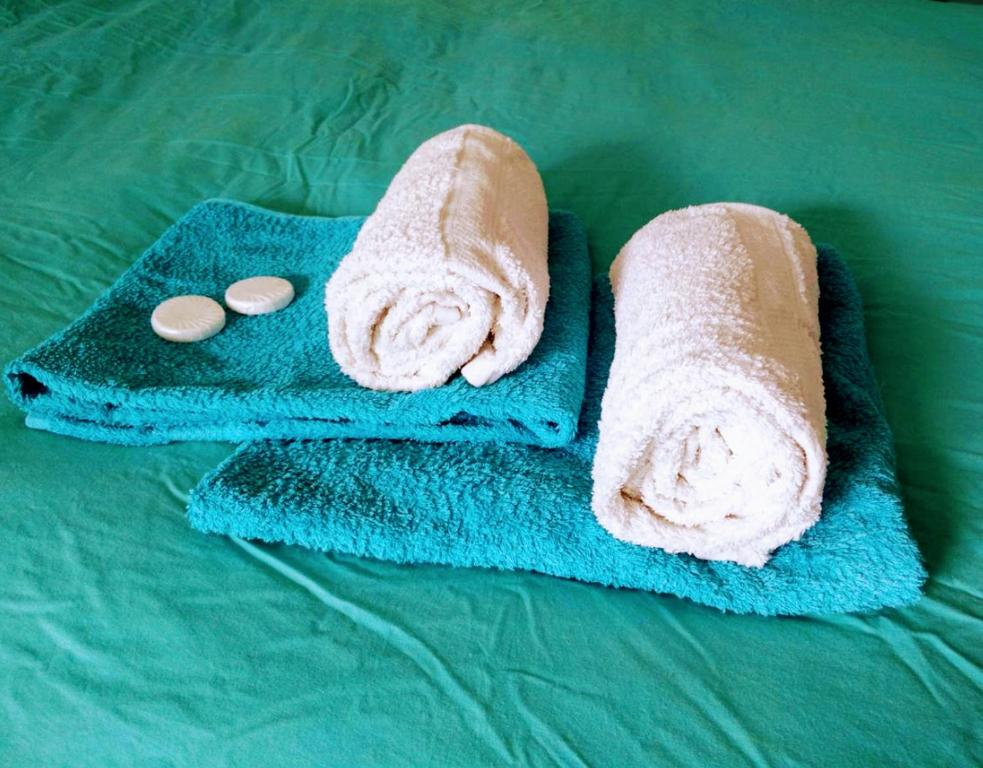 two towels with two pills on a bed at H 58 in Amsterdam