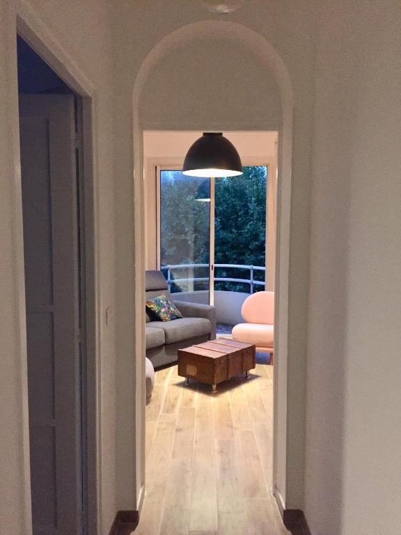 a hallway with a living room with a couch and a table at Centre ville Perpignan - Le Castillet in Perpignan