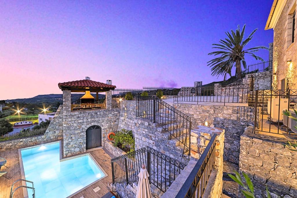 a villa with a swimming pool and a building at Acrothea Villa Heated Pool in Chania Town