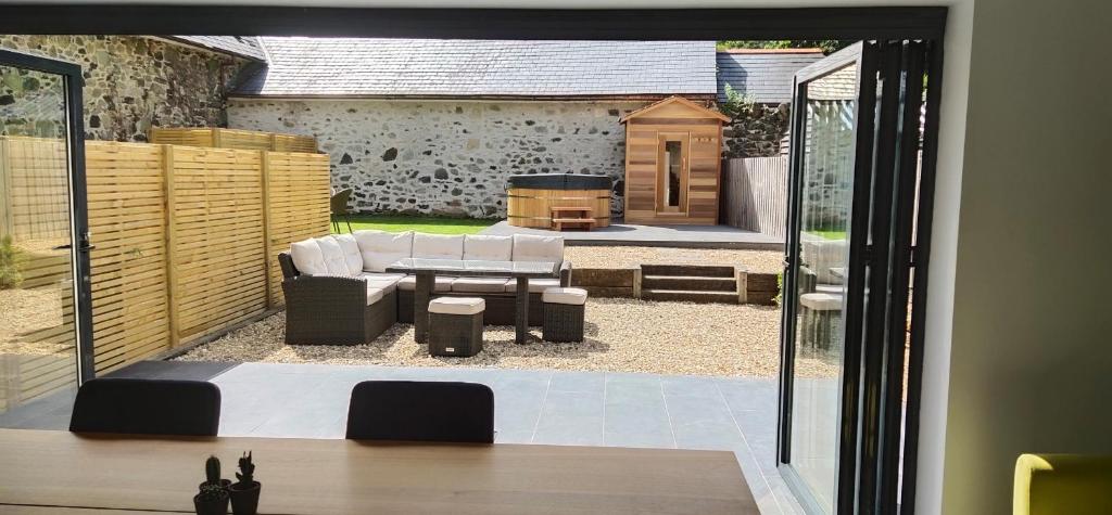 a view of a patio with a table and a grill at Tawburn House Boutique B & B in Okehampton