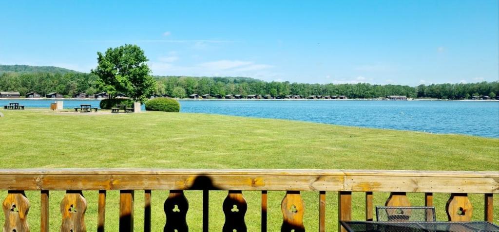 a wooden fence with a view of a lake at Fenna Lakeside Lodge - Pine Lake Resort in Carnforth