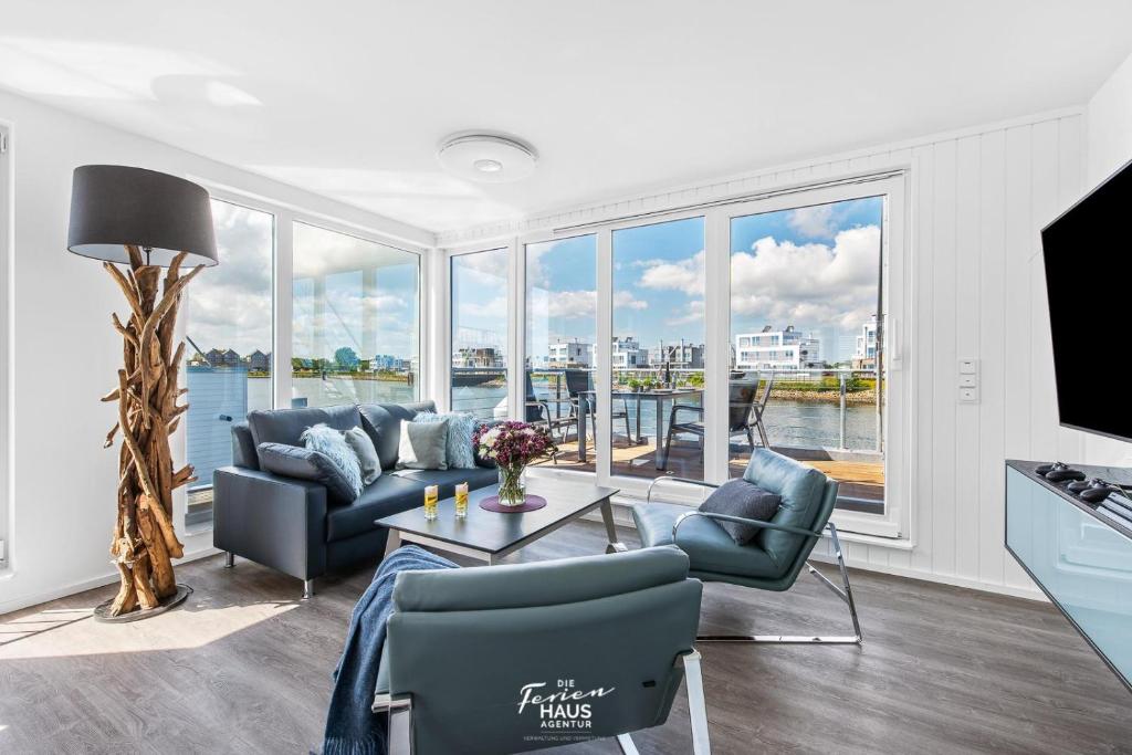 a living room with a couch and chairs and a table at Sunseeker in Olpenitz