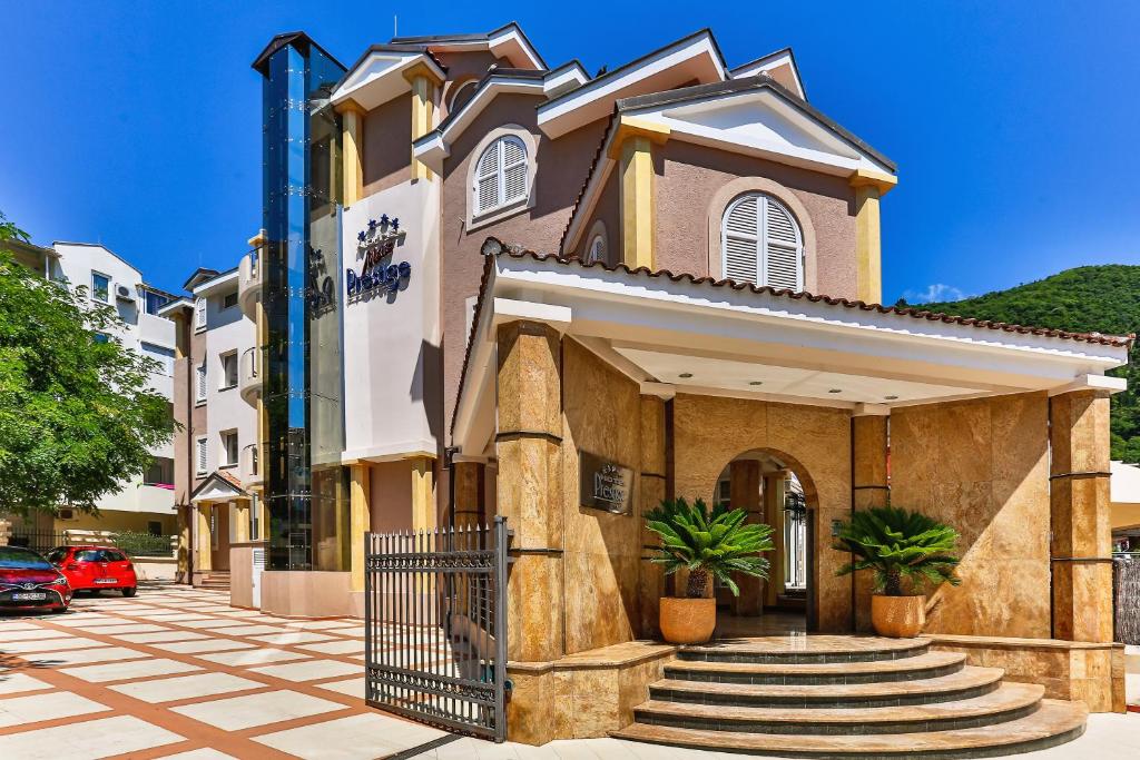 a building with a gate on a street at Hotel Max Prestige in Budva