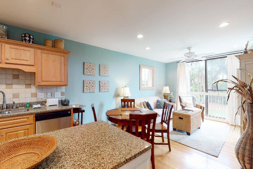 a kitchen with a table and a living room at Shipwatch 2173 in Kiawah Island