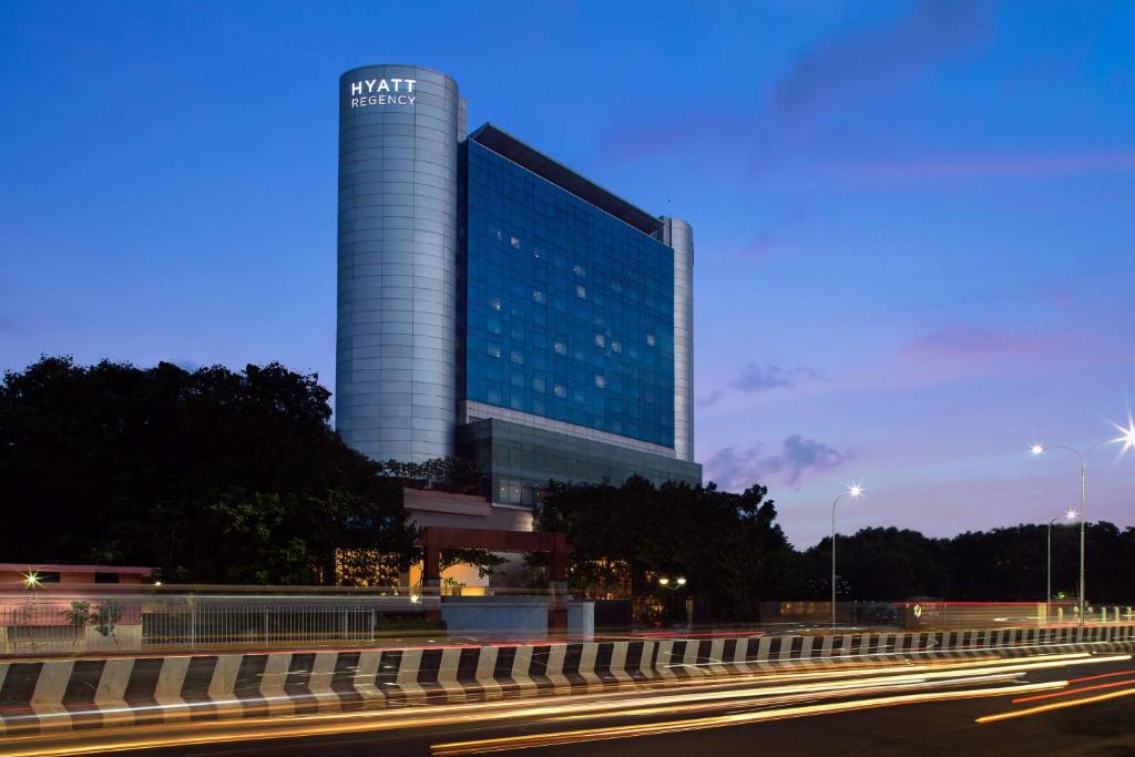 
a city street at night with a large building at Hyatt Regency Chennai in Chennai

