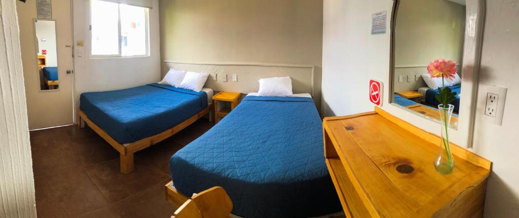 Postel nebo postele na pokoji v ubytování Hotel Tecnologico