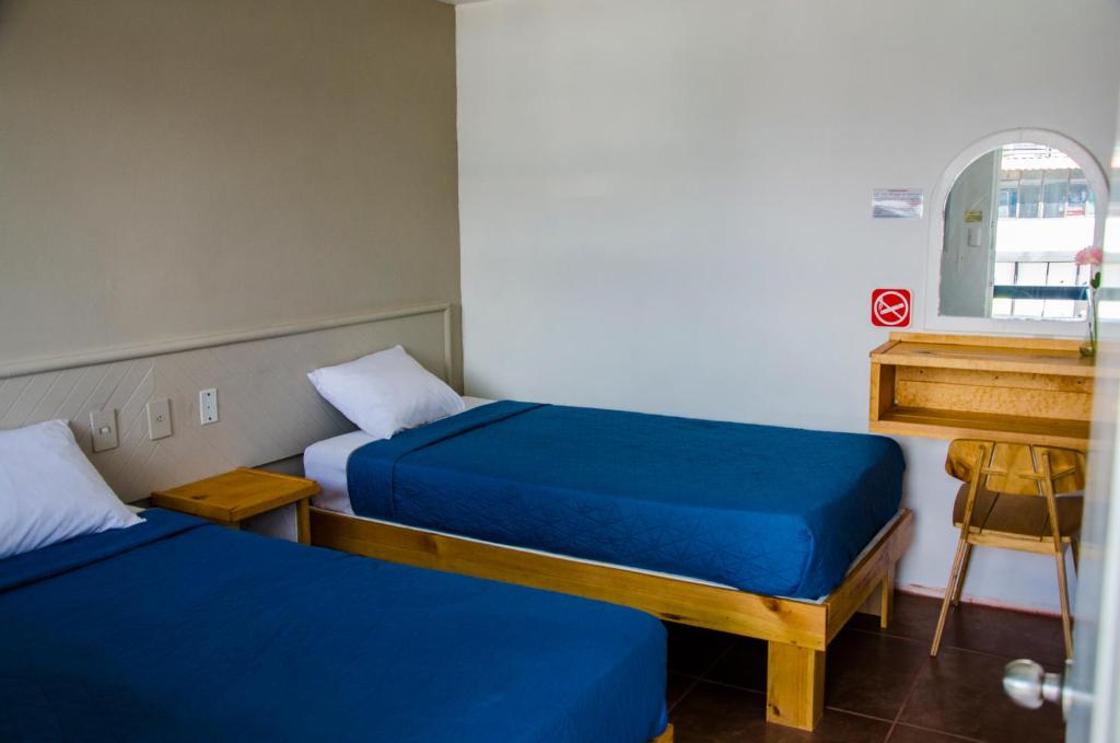 Postel nebo postele na pokoji v ubytování Hotel Tecnologico