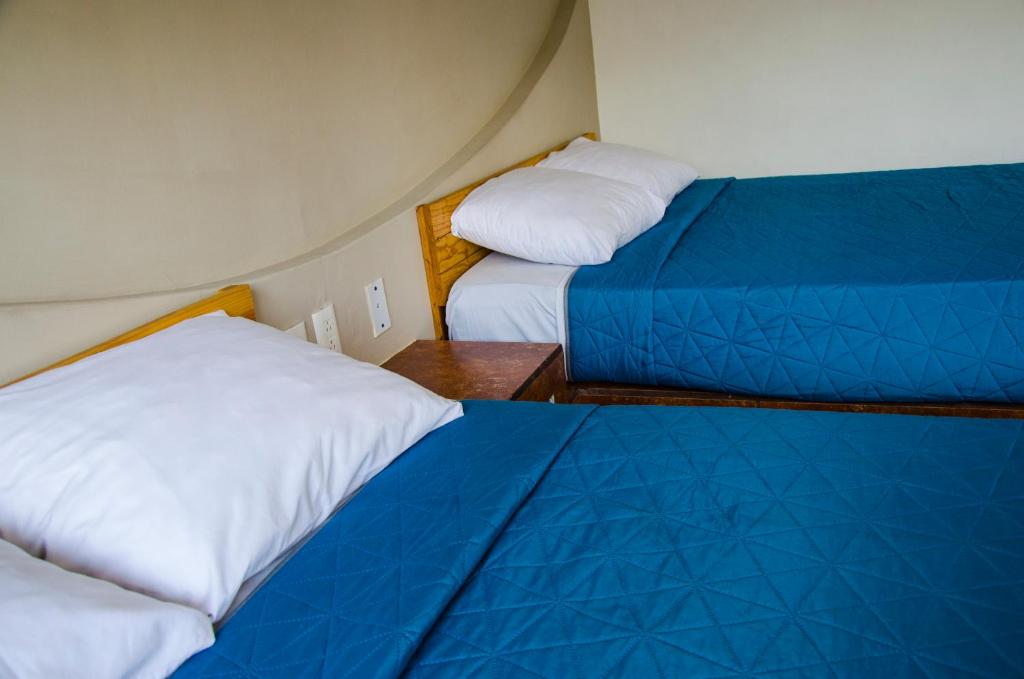 Postel nebo postele na pokoji v ubytování Hotel Tecnologico