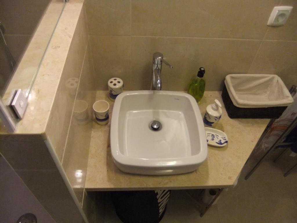 a white sink in a bathroom with a counter at Casa Mateus - Colares, Parque Natural Sintra Cascais in Sintra