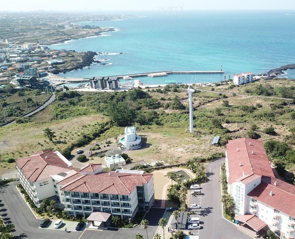 an aerial view of a building next to the ocean at Blue Hawaii Resort in Jeju