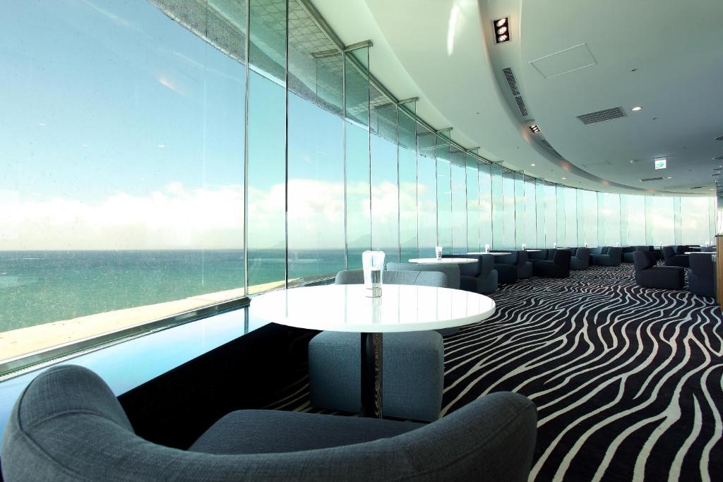 a room with a table and chairs in front of a window at H Resort in Checheng