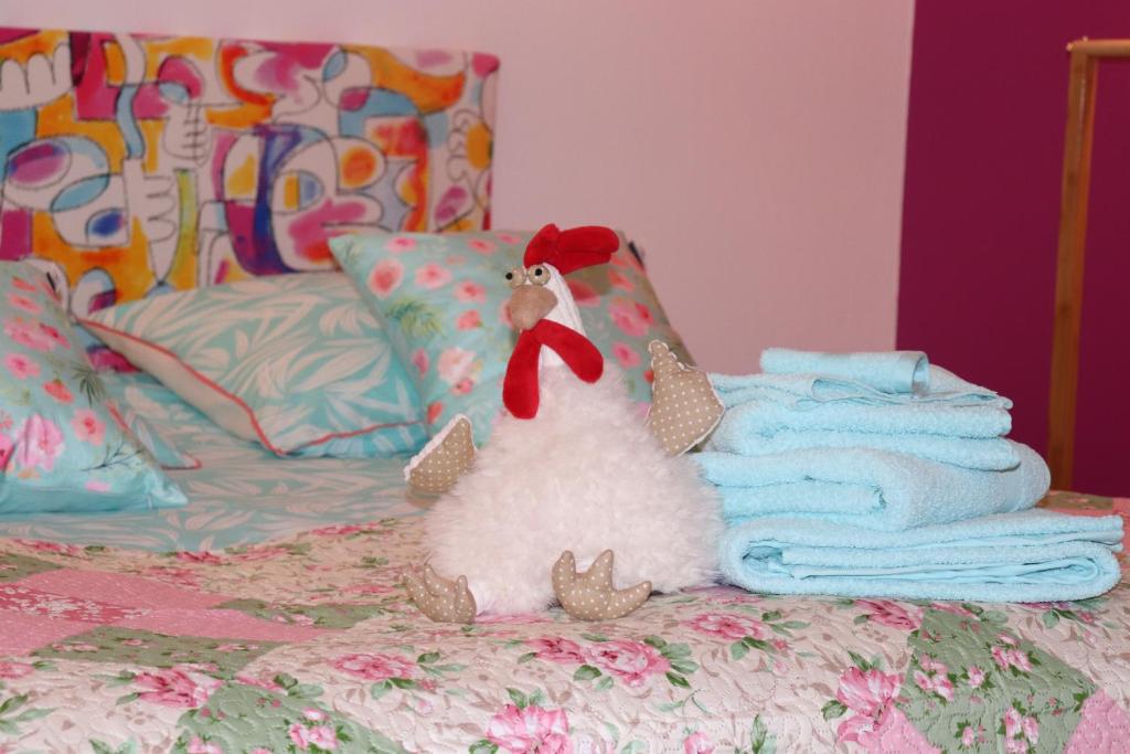 a stuffed animal sitting on a bed with towels at Le studio de Manoline in Bourges