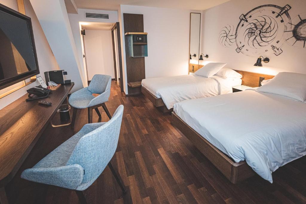 Posteľ alebo postele v izbe v ubytovaní Hotel Bernina Geneva