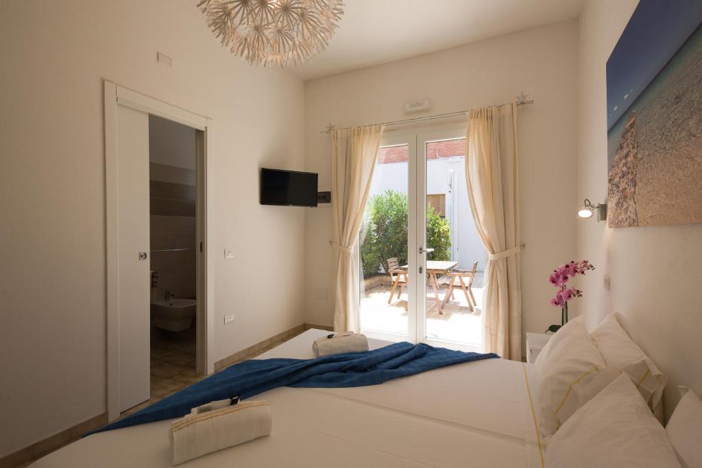 a bedroom with a bed and a view of a patio at Coru e Mari - City Center & Private Parking in Pula