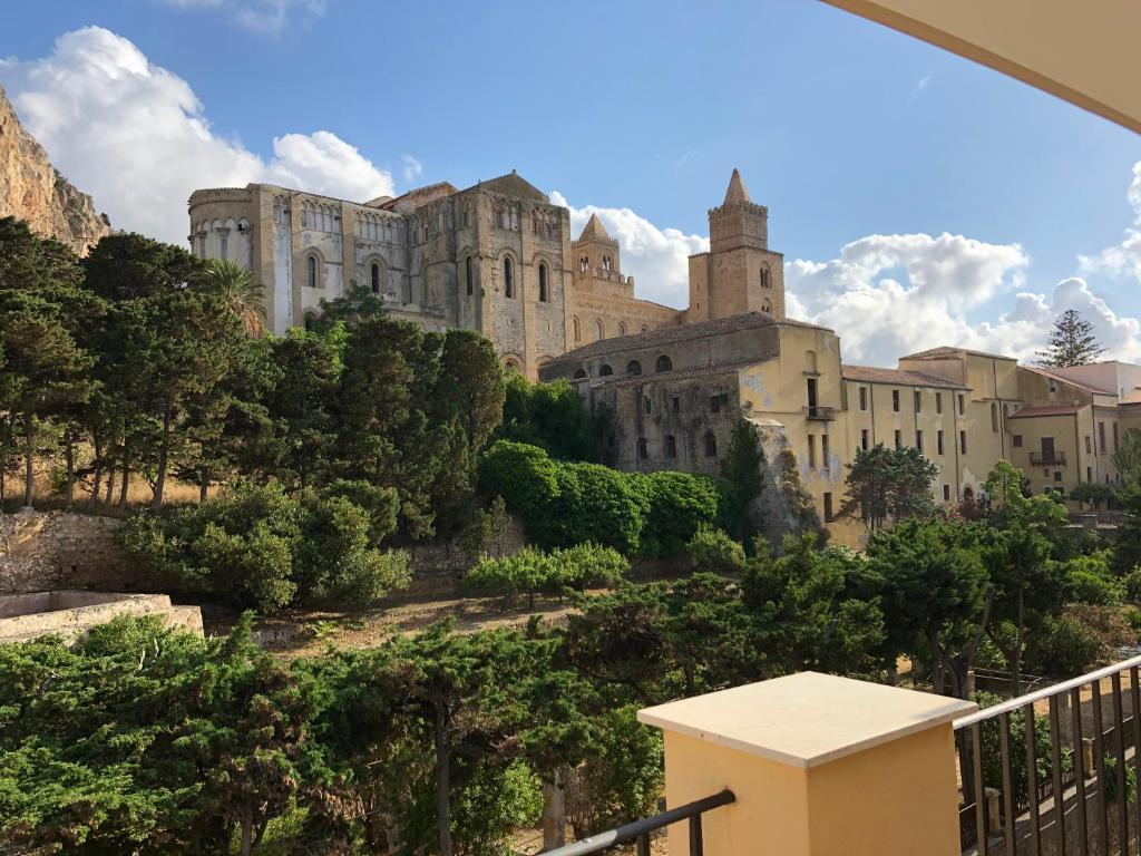 a castle on top of a hill with trees at La Casa Sulla Scogliera in Cefalù