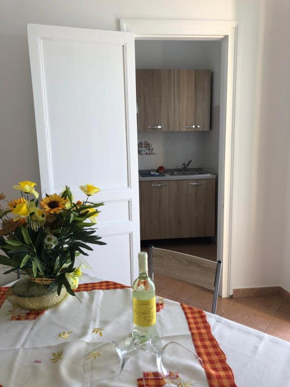 a bottle of wine on a table in a kitchen at La Casa Sulla Scogliera in Cefalù