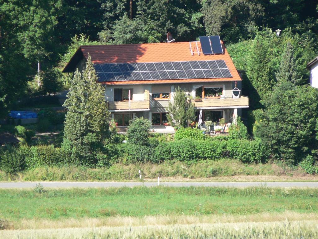 a house with solar panels on the roof at Brands Appartement in Ober-Nauses
