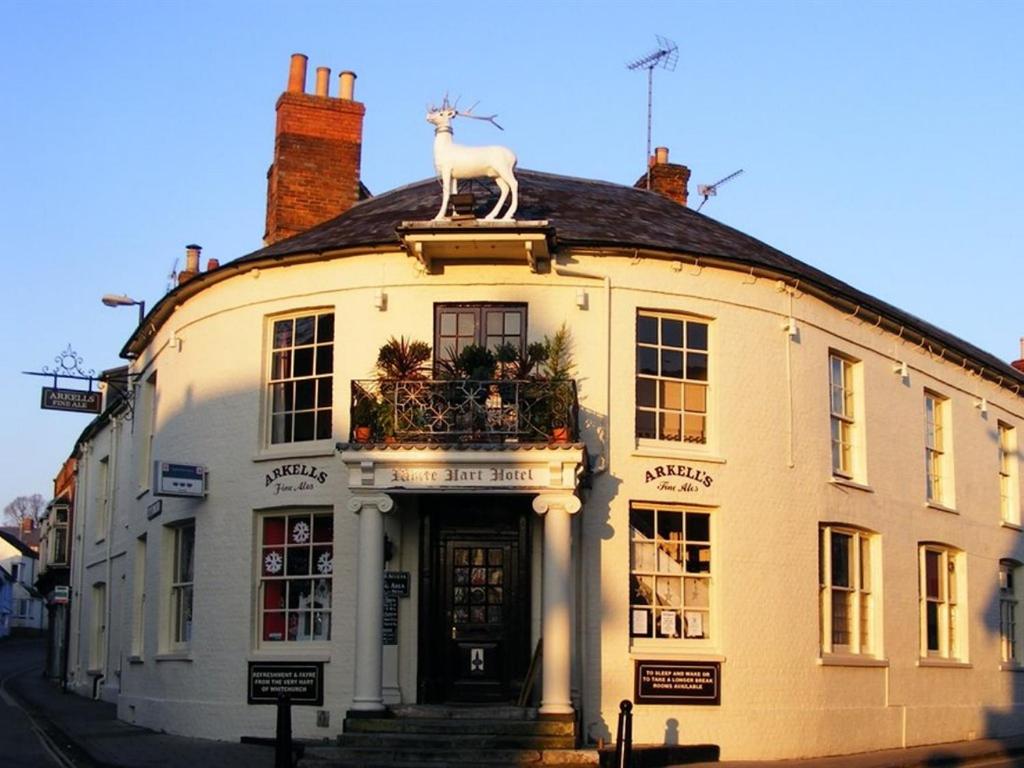 a building with a statue of a goat on the roof at The White Hart in Whitchurch