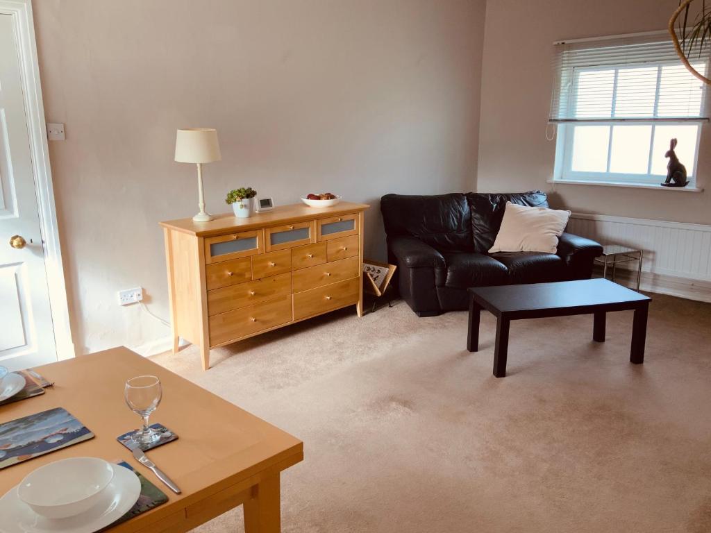 a living room with a couch and a table at The Stables Apartment in Newark upon Trent