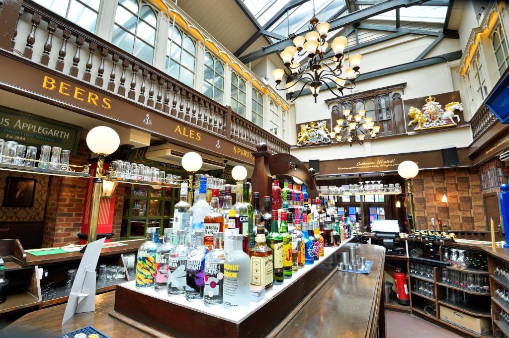 a store filled with lots of bottles of alcohol at The Royal Victoria and Bull Hotel in Dartford