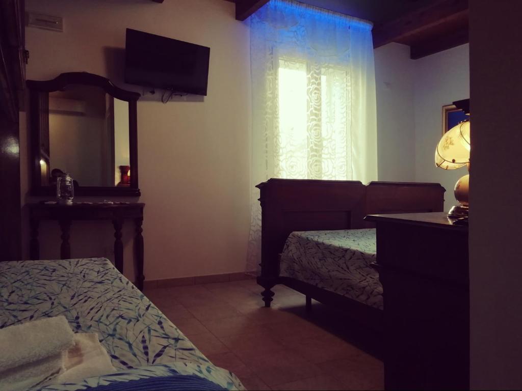Postel nebo postele na pokoji v ubytování Le mille e una notte